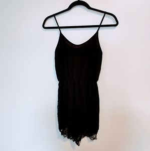 Black romper size small with lace detail at the leg